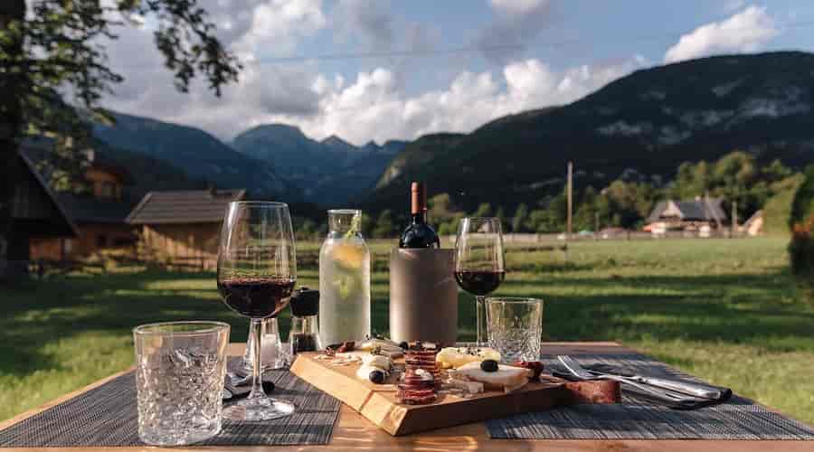 Outdoor dining with charcuterie, wine, and mountain view at Majerca Restaurant