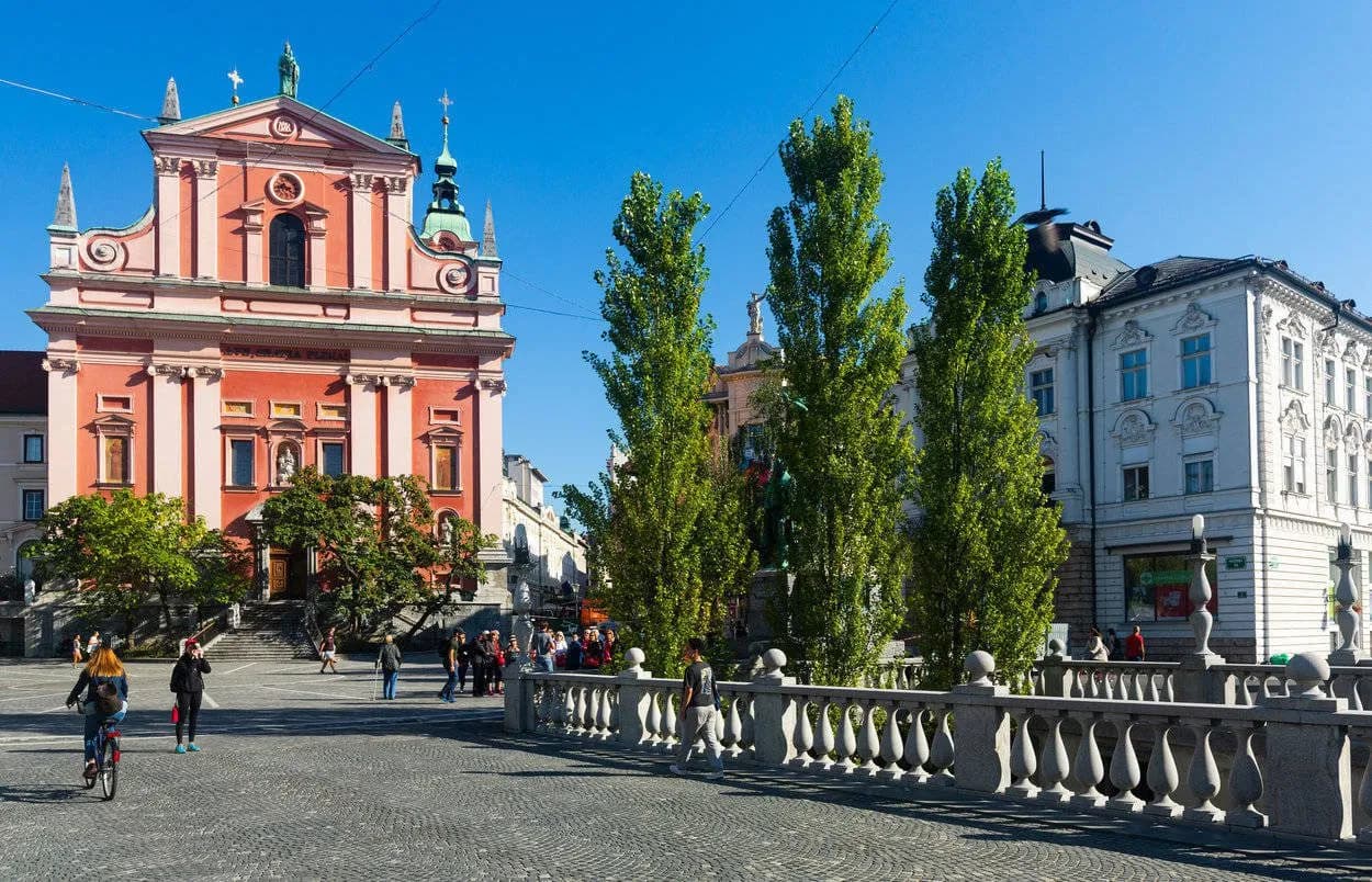 Preseren Square in Ljubljana with the pink Franciscan Church and cobblestones.