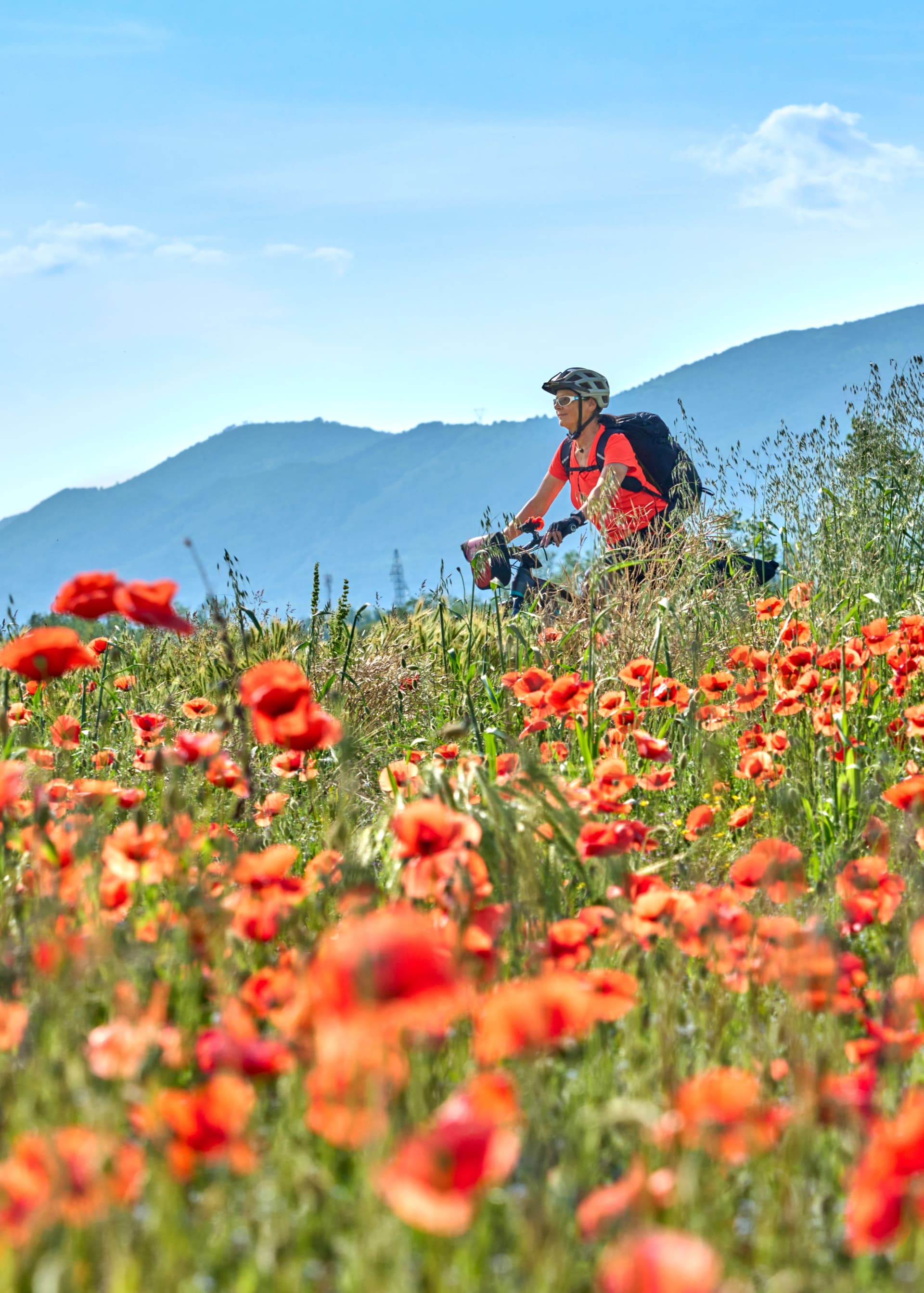 nice senior woman on a bike tour with her electric mountain bike in the Karst Mountains of Slovenia near Solkan