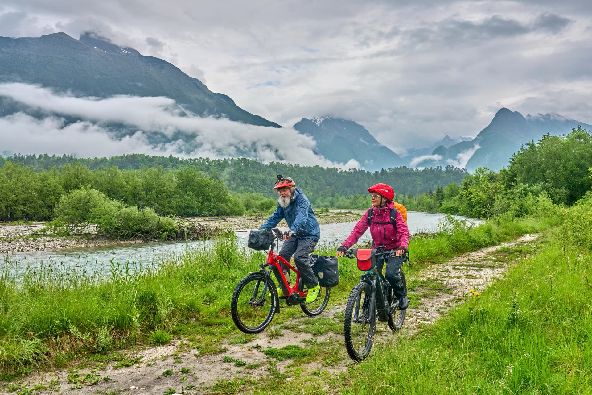 active senior couple on a e-bike tour in the Valley of River Soca, Triglav National Park near Bovec, Slovenia